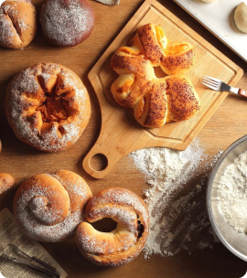 different bakery products are lying on the table and one is on the desk